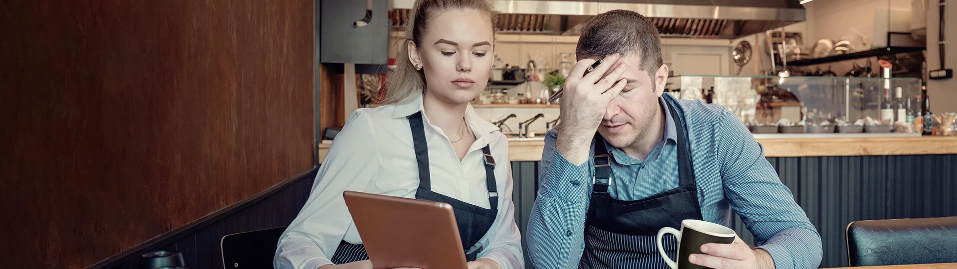 Women showing a man something on a tablet